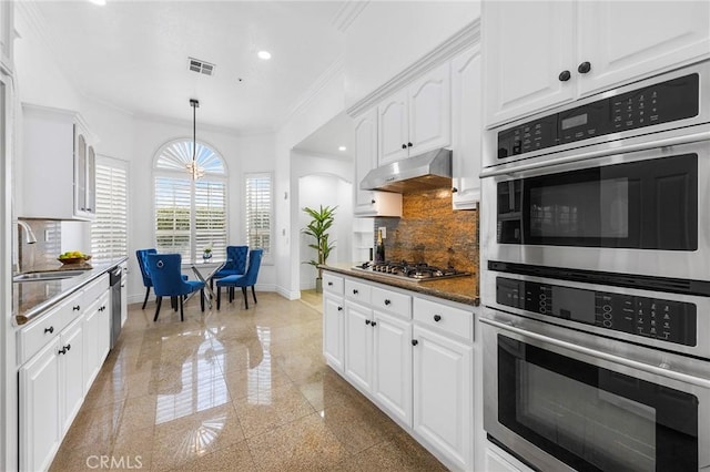 14121 Exeter Ct, Fontana, CA 92336 - kitchen featuring a sink, baseboards, under cabinet range hood, ornamental molding, and white cabinetry
