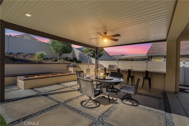 29042 Botanical Cir, Menifee, CA 92584 - patio terrace at dusk featuring a patio area, a fenced backyard, ceiling fan, and outdoor dining area