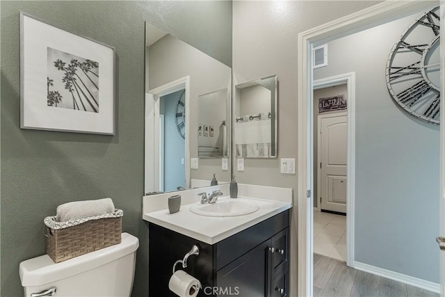 29042 Botanical Cir, Menifee, CA 92584 - bathroom with toilet, vanity, and baseboards