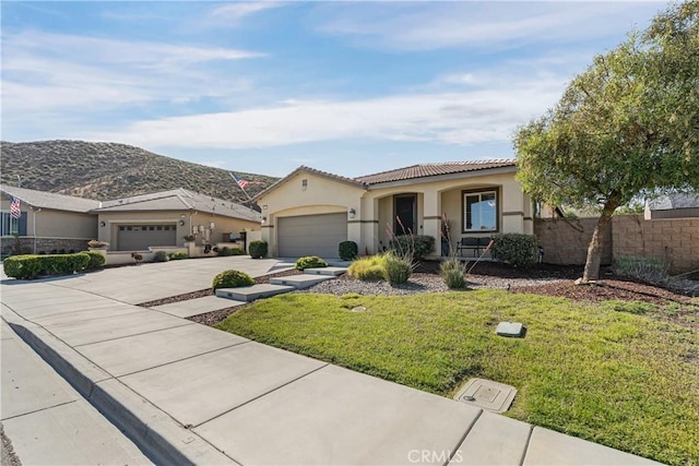 29042 Botanical Cir, Menifee, CA 92584 - mediterranean / spanish home featuring concrete driveway, a garage, stucco siding, a tile roof, and a mountain view