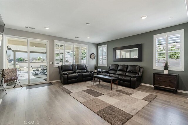 29042 Botanical Cir, Menifee, CA 92584 - living room featuring baseboards, light wood-type flooring, plenty of natural light, and recessed lighting