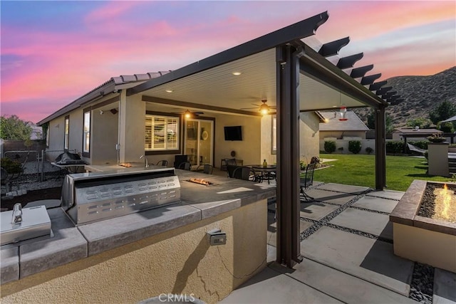 29042 Botanical Cir, Menifee, CA 92584 - view of patio featuring exterior kitchen and an outdoor fire pit