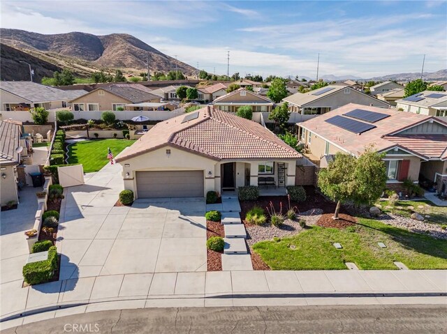 29042 Botanical Cir, Menifee, CA 92584 - mediterranean / spanish home featuring a residential view, driveway, a garage, stucco siding, and a tiled roof