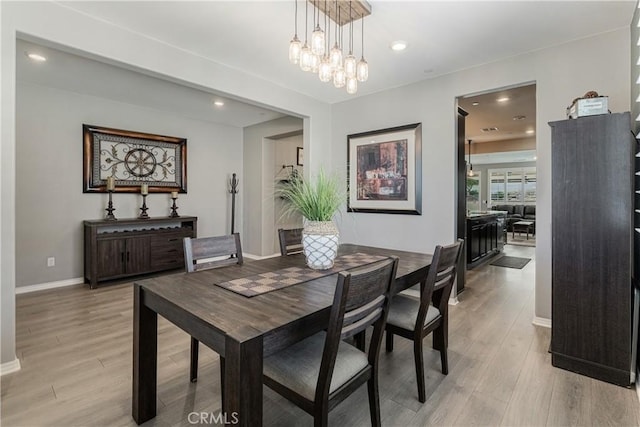 29042 Botanical Cir, Menifee, CA 92584 - dining space with light wood-type flooring, baseboards, a chandelier, and recessed lighting