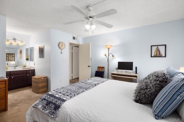 7780 Parkway Dr Unit 703, La Mesa, CA 91942 - bedroom with light carpet, connected bathroom, a textured ceiling, and a ceiling fan
