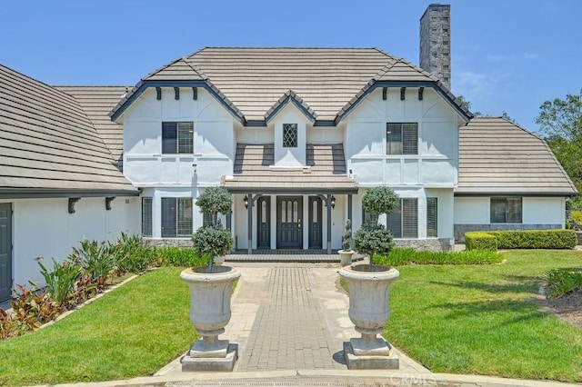 25570 Fuerte Rd, Temecula, CA 92590 - english style home with stucco siding, covered porch, a front yard, and a chimney