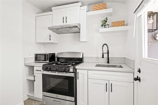 453 N Walker Ave, San Pedro, CA 90732 - kitchen with open shelves, under cabinet range hood, stainless steel appliances, a sink, and light countertops
