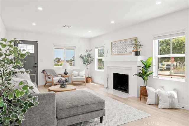 453 N Walker Ave, San Pedro, CA 90732 - living room featuring plenty of natural light, recessed lighting, a fireplace with flush hearth, light wood-style floors, and baseboards