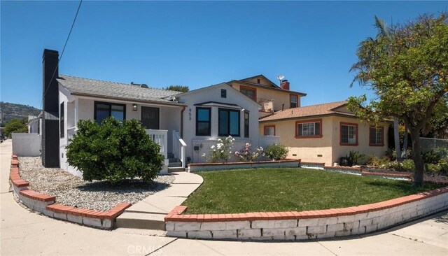 453 N Walker Ave, San Pedro, CA 90732 - view of front of house with stucco siding, a front lawn, and a chimney