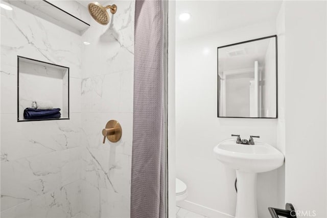 453 N Walker Ave, San Pedro, CA 90732 - full bathroom with tiled shower, toilet, and marble finish flooring