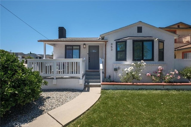 453 N Walker Ave, San Pedro, CA 90732 - view of front of property with a chimney, a front yard, stucco siding, and a porch