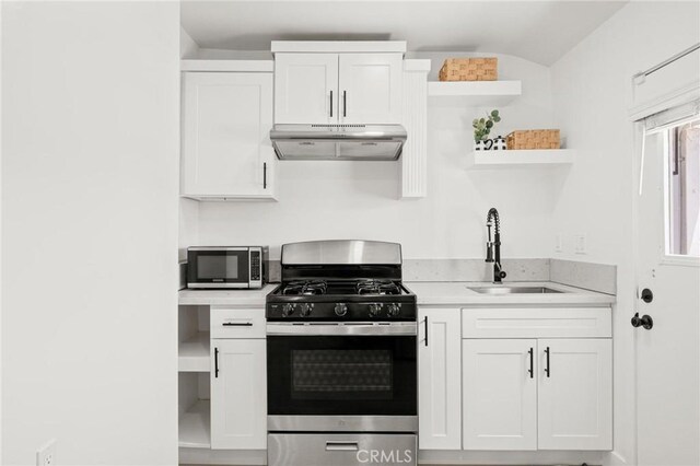 453 N Walker Ave, San Pedro, CA 90732 - kitchen with appliances with stainless steel finishes, under cabinet range hood, a sink, open shelves, and light countertops