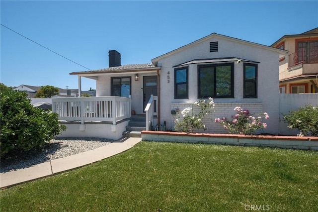 453 N Walker Ave, San Pedro, CA 90732 - view of front of home featuring a chimney, a front lawn, stucco siding, and a porch