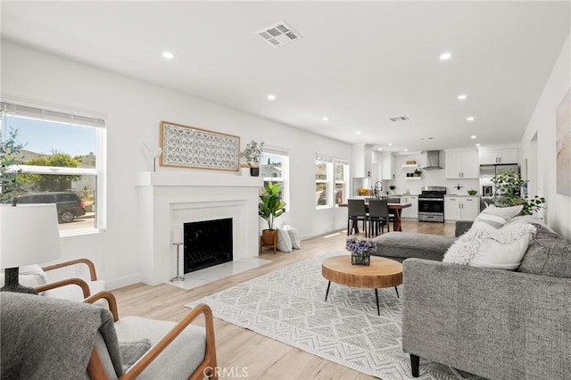 453 N Walker Ave, San Pedro, CA 90732 - living room with recessed lighting, a fireplace with flush hearth, light wood finished floors, and baseboards