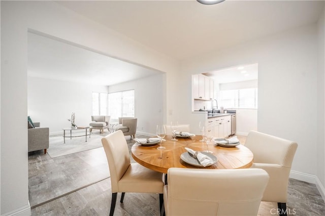 46 Echo Run Unit 16, Irvine, CA 92614 - dining room with plenty of natural light, baseboards, and light wood-style floors
