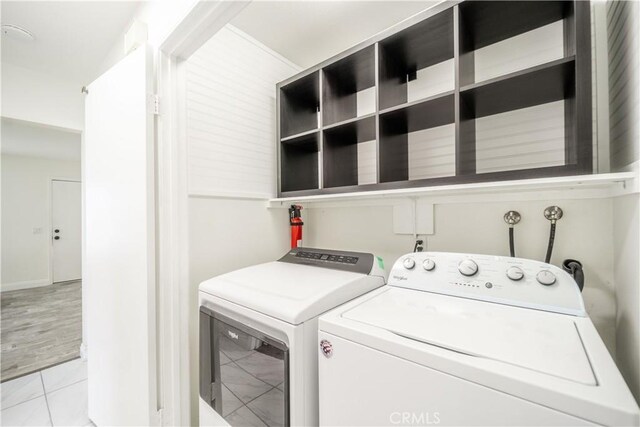 46 Echo Run Unit 16, Irvine, CA 92614 - laundry room with washer and clothes dryer and light tile patterned floors
