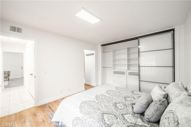 46 Echo Run Unit 16, Irvine, CA 92614 - bedroom with light wood-type flooring and baseboards