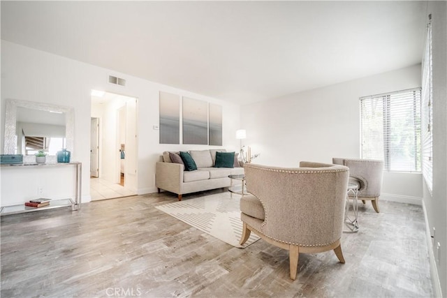 46 Echo Run Unit 16, Irvine, CA 92614 - living room with healthy amount of natural light, light wood-style flooring, and baseboards