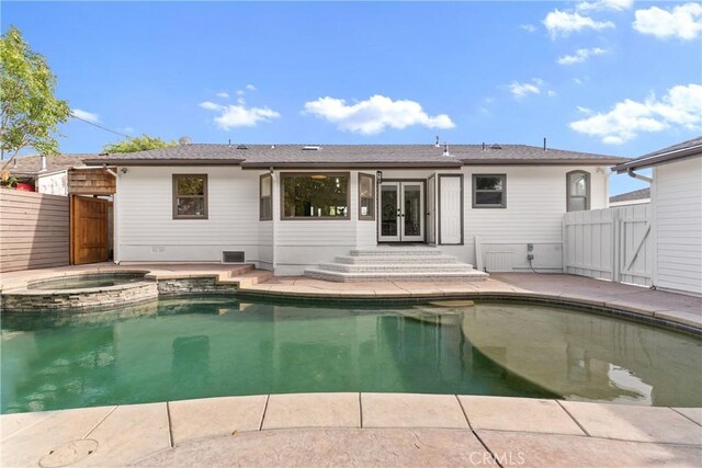 2011 Reynosa Dr, Torrance, CA 90501 - back of property with french doors, a gate, a pool with connected hot tub, a patio, and crawl space