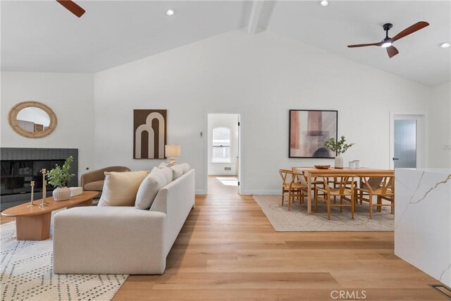 2011 Reynosa Dr, Torrance, CA 90501 - living room with a ceiling fan, light wood-style flooring, beamed ceiling, a fireplace, and high vaulted ceiling