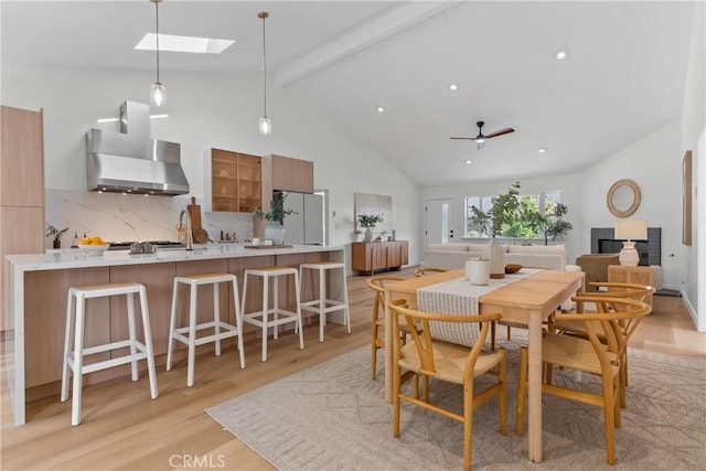 2011 Reynosa Dr, Torrance, CA 90501 - dining room featuring beam ceiling, light wood-type flooring, a skylight, a ceiling fan, and high vaulted ceiling