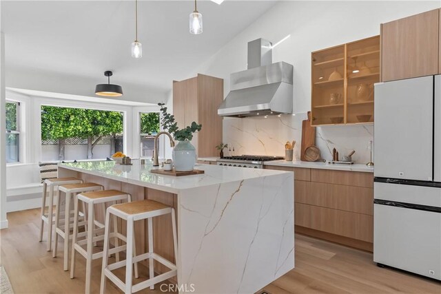 2011 Reynosa Dr, Torrance, CA 90501 - kitchen featuring freestanding refrigerator, wall chimney exhaust hood, modern cabinets, light wood-style flooring, and high vaulted ceiling