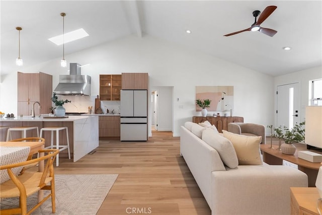 2011 Reynosa Dr, Torrance, CA 90501 - living area featuring beamed ceiling, a skylight, high vaulted ceiling, light wood-style flooring, and a ceiling fan