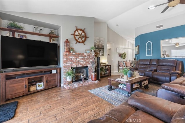 27141 Calle Ayrton, Menifee, CA 92586 - living room with ceiling fan, vaulted ceiling, wood finished floors, and a fireplace