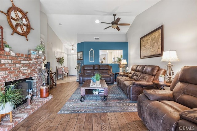 27141 Calle Ayrton, Menifee, CA 92586 - living room featuring lofted ceiling, ceiling fan, wood-type flooring, and a brick fireplace