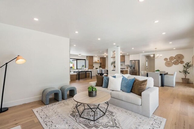 1932 Chapman Rd, Claremont, CA 91711 - living area featuring recessed lighting, light wood-style flooring, baseboards, and a chandelier