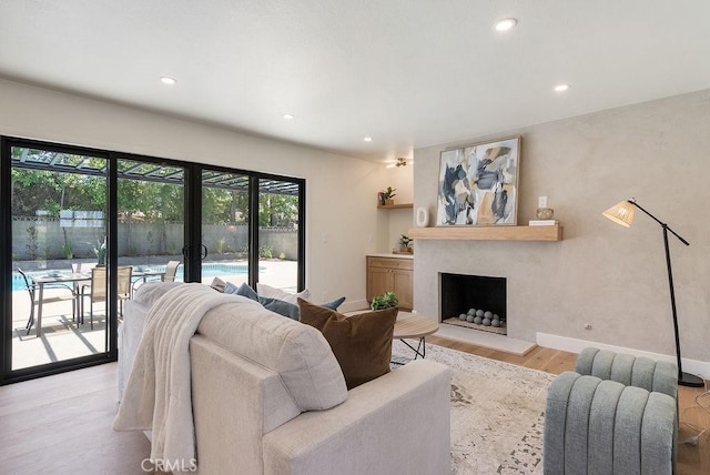 1932 Chapman Rd, Claremont, CA 91711 - living area with wood finished floors, recessed lighting, a fireplace with raised hearth, french doors, and baseboards