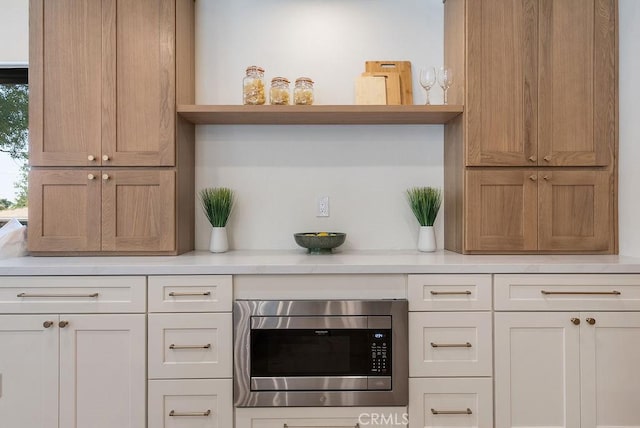1932 Chapman Rd, Claremont, CA 91711 - kitchen view of stainless steel microwave, open shelves, and light countertops