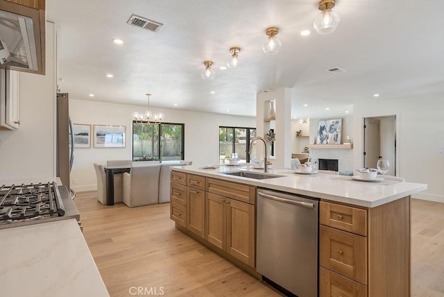 1932 Chapman Rd, Claremont, CA 91711 - kitchen featuring dishwasher, a sink, light wood finished floors, a chandelier, and open floor plan