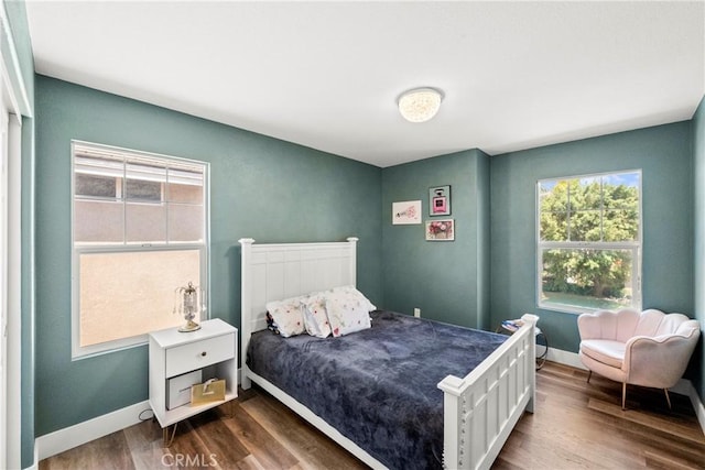 29889 Warm Sands Dr, Menifee, CA 92584 - bedroom with multiple windows, dark wood finished floors, and baseboards