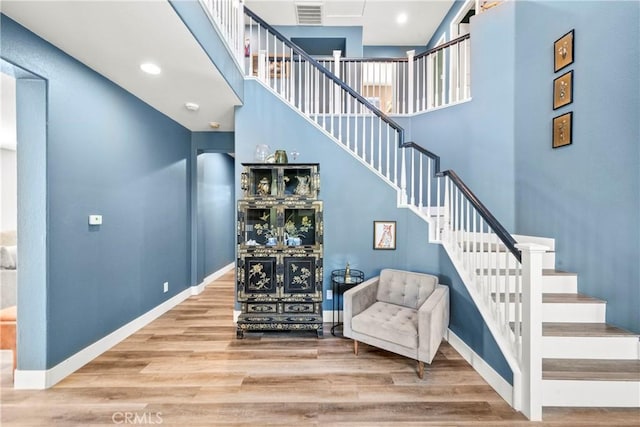 29889 Warm Sands Dr, Menifee, CA 92584 - stairs featuring a high ceiling, wood finished floors, and baseboards