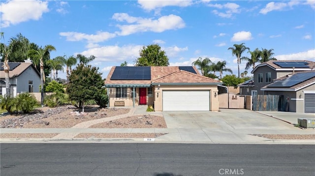 959 Corwin Pl, Hemet, CA 92544 - ranch-style house featuring a garage, solar panels, driveway, a gate, and stucco siding