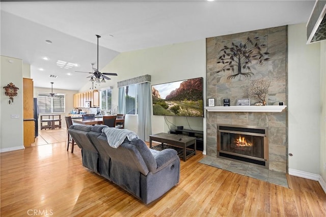 959 Corwin Pl, Hemet, CA 92544 - living area featuring vaulted ceiling, a fireplace, a ceiling fan, wood finished floors, and baseboards