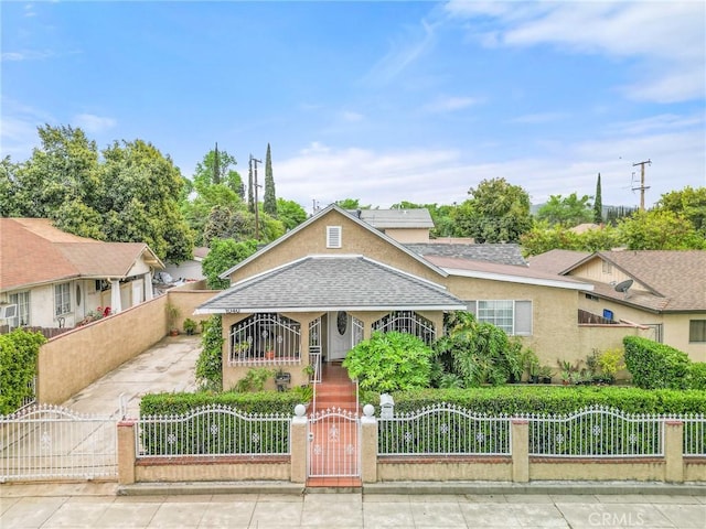 1040 W 3rd St, Pomona, CA 91766 - view of front of house with roof with shingles, a fenced front yard, a gate, and stucco siding