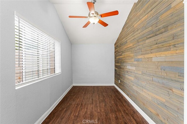 1040 W 3rd St, Pomona, CA 91766 - spare room with lofted ceiling, wood walls, wood finished floors, a ceiling fan, and baseboards