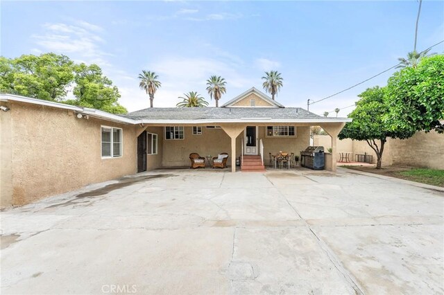 1040 W 3rd St, Pomona, CA 91766 - back of property with stucco siding and entry steps