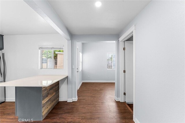 1040 W 3rd St, Pomona, CA 91766 - hall with dark wood-style floors, baseboards, and a desk