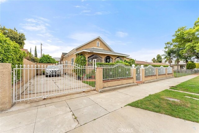 1040 W 3rd St, Pomona, CA 91766 - view of front of home featuring a fenced front yard and a gate