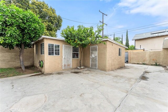 1040 W 3rd St, Pomona, CA 91766 - back of property featuring stucco siding and a patio