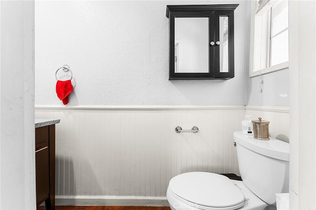 1040 W 3rd St, Pomona, CA 91766 - half bathroom featuring vanity, toilet, and wainscoting