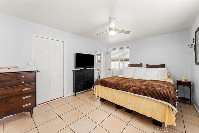 1040 W 3rd St, Pomona, CA 91766 - bedroom with light tile patterned floors, a ceiling fan, and baseboards