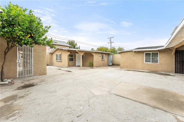 1040 W 3rd St, Pomona, CA 91766 - back of house featuring stucco siding and a patio area