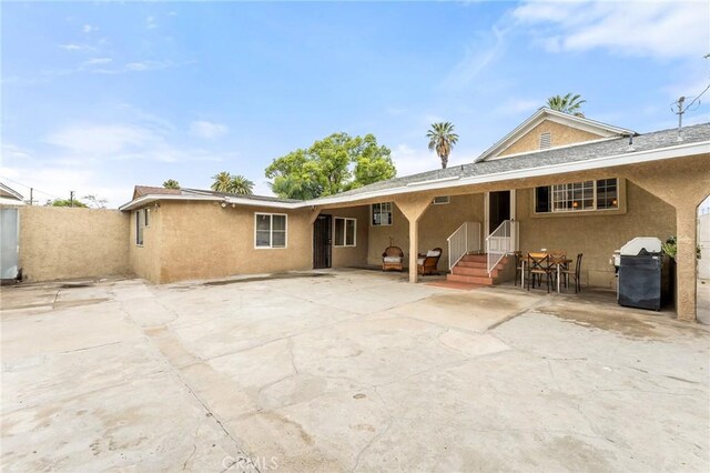 1040 W 3rd St, Pomona, CA 91766 - rear view of property featuring stucco siding and a patio area