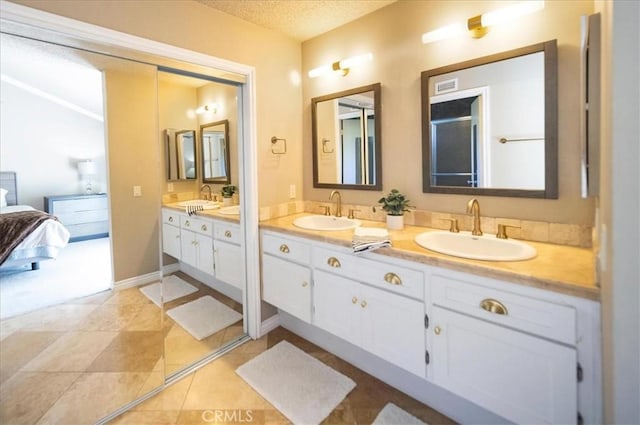 29911 Cactus Pl, Temecula, CA 92592 - ensuite bathroom featuring double vanity and a textured ceiling