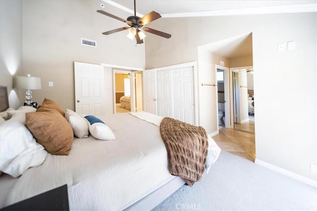 29911 Cactus Pl, Temecula, CA 92592 - bedroom featuring light carpet, high vaulted ceiling, a closet, baseboards, and ensuite bath