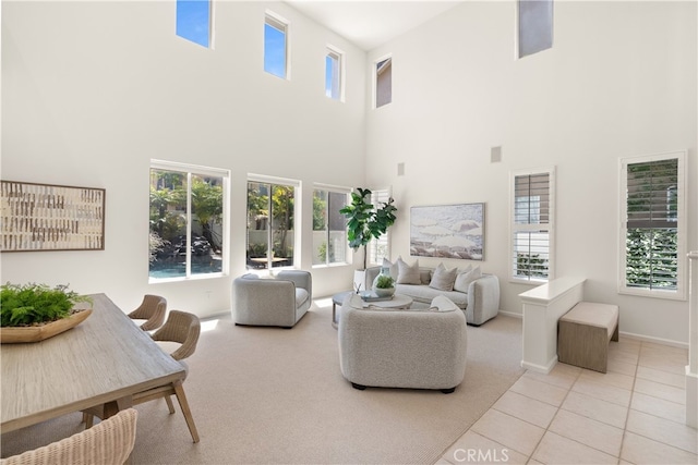 19139 Chandon Ln, Huntington Beach, CA 92648 - carpeted living area with a high ceiling, plenty of natural light, tile patterned flooring, and baseboards